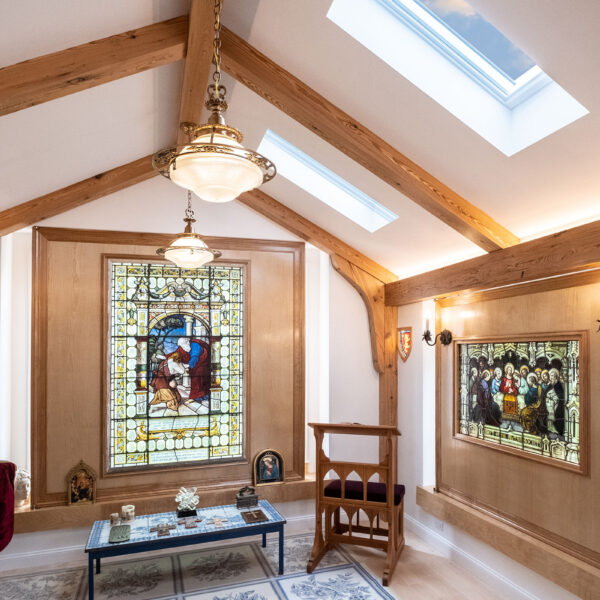 In this custom home chapel pendant lights hang from a beam made of heartwood from reclaimed local lumber.